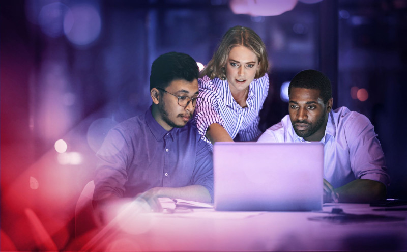 People gathered round a laptop